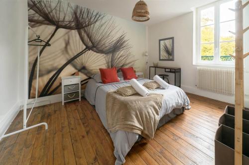 a bedroom with a bed with red pillows on it at Résidence Epinat - Appartements centre & parking in Vichy