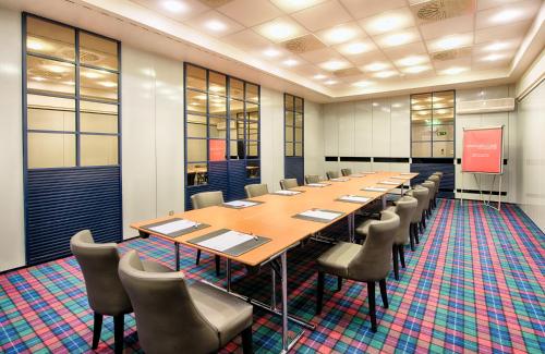 a large conference room with a long table and chairs at Leonardo Royal Hotel Düsseldorf Königsallee in Düsseldorf