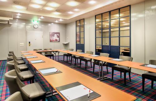 a large room with rows of tables and chairs at Leonardo Royal Hotel Düsseldorf Königsallee in Düsseldorf