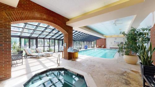 an indoor swimming pool in a house with a brick wall at The Simsbury Inn in Simsbury
