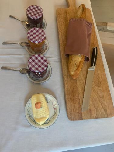 a table with a plate of bread and some cupcakes at Maison de la Pra in Valence