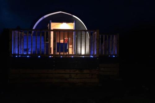 a building with an arched window at night at Dalrigh Pod in Onich