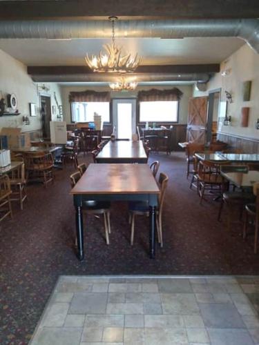a dining room with tables and chairs and a chandelier at Eagle Rock Resort in Naches
