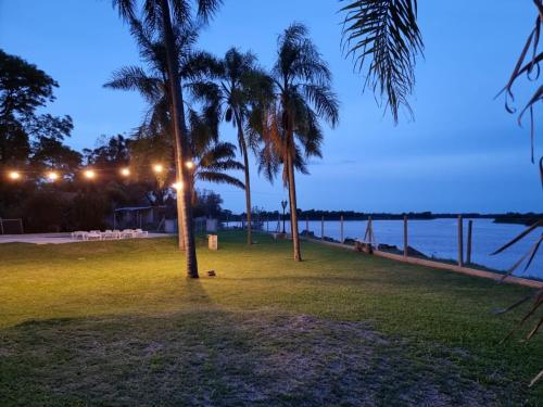 um parque com palmeiras e o oceano à noite em (12 pers. o +) Casa quinta con pileta sobre el río PRECIO DOLAR BILLETE em Santa Fé