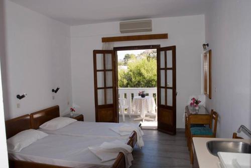 a bedroom with a bed and a sink and a window at Hermes in Kalymnos