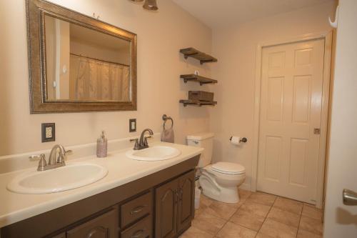 a bathroom with two sinks and a toilet at Sunnyside home near Sunday River, Black Mountain, Lakes and Hikes in Rumford