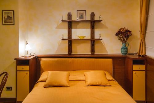 a bedroom with a bed with two shelves on the wall at Residence Týnská in Prague