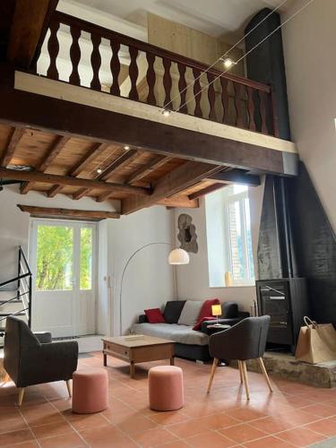 a living room with a couch and a table at Votre gite dans l'ancienne Huilerie de Tourtel in Vernosc-lès-Annonay