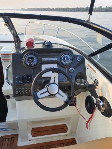 a steering wheel of a boat on the water at Apartment Kula Đurišić in Perast