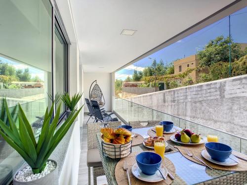 a dining room with a table with food on a balcony at Uptown Apartment by LovelyStay in Funchal
