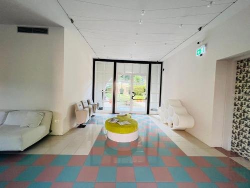 a room with a couch and a table on a colorful floor at hotel garni Santa Caterina in Orta San Giulio