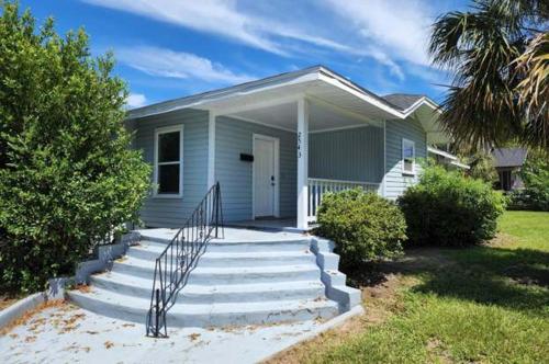 a blue house with stairs in front of it at The Jewel of Jacksonville in Jacksonville