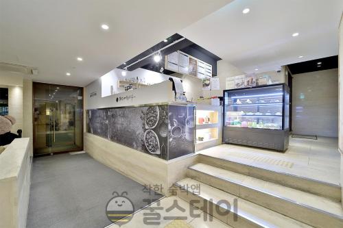 a store lobby with stairs and a refrigerator at Golden Hotel Incheon in Incheon