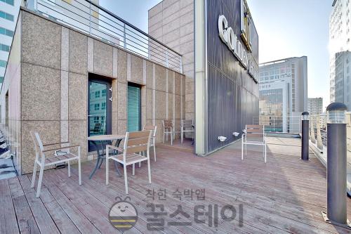 a balcony with chairs and a table on a building at Golden Hotel Incheon in Incheon