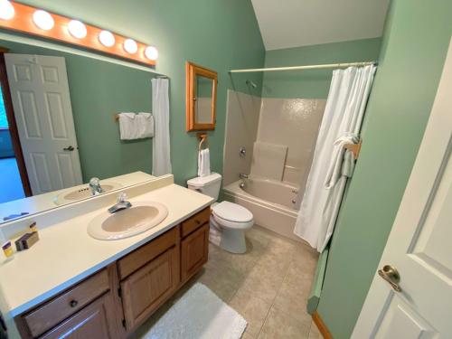 a bathroom with a sink and a toilet and a shower at MWP59 Mount Wash Place Townhome fireplace large deck yard in Carroll