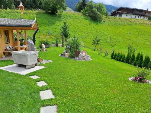 a garden with a stone pathway in the grass at Ferienwohnung Widmann in Jochberg
