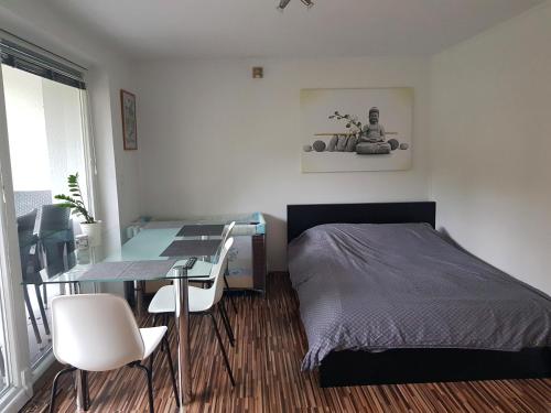 a bedroom with a bed and a desk and a table at Apartment Dolce Vita in Celje