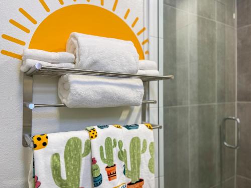 a bathroom with white towels and a shower at Casa Del Sol in Phoenix