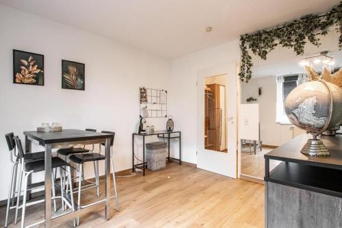 a living room with a table and chairs and a vase at Ein Stück Heimat mit Netflix in Bielefeld