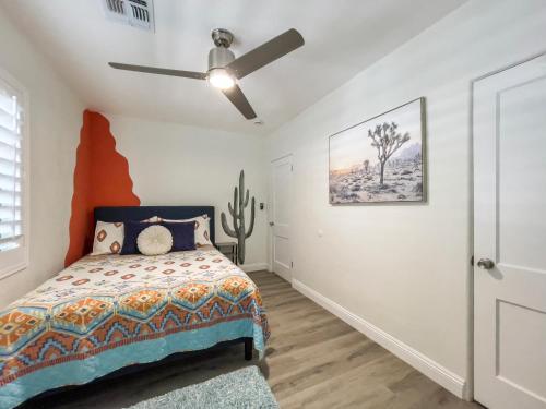 a bedroom with a bed and a ceiling fan at Casa Del Sol in Phoenix