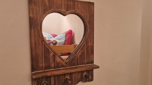 a mirror with a wooden frame on a wall at Ferienwohnung Maggie - Sankt Englmar in Sankt Englmar