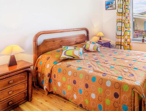 a bedroom with a bed and a wooden dresser and a bed sidx sidx sidx at Alkisti City Hotel in Larnaka