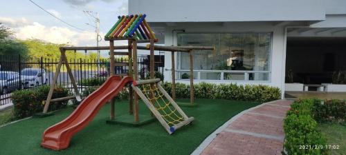 a playground with a slide in a yard at Aqualina Green Girardot in Girardot
