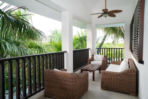 a porch with chairs and a ceiling fan at Hotel Casa Hemingway in Juan Dolio