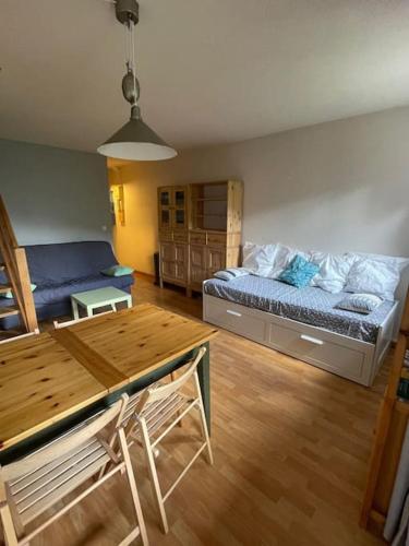 une chambre avec un lit et une table et une salle à manger dans l'établissement Le Seignus d'Allos T2 30m2. Aux pieds des pistes., à Allos