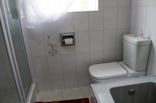 a bathroom with a toilet and a shower at Bougainvillea at Boskruin in Johannesburg