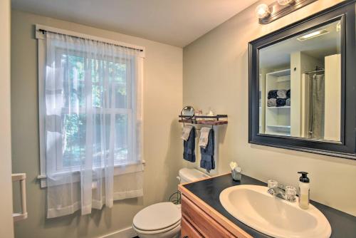 a bathroom with a sink and a toilet and a window at Wild Goose Cottage on Little Lake Sunapee! in New London