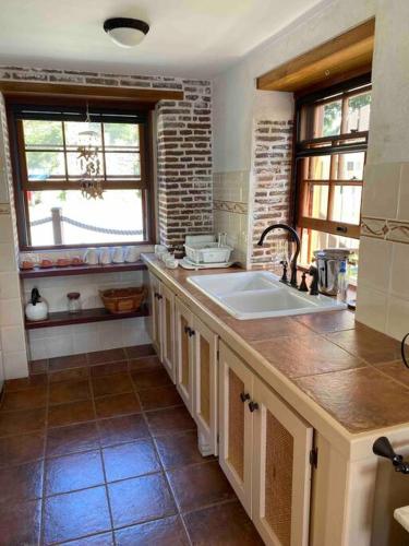 a kitchen with a sink and a counter top at Barrel House Suite St Eustatius in Oranjestad