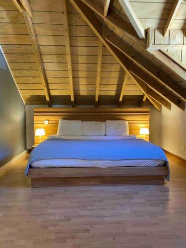 a bedroom with a bed in an attic at Barrel House Suite St Eustatius in Oranjestad
