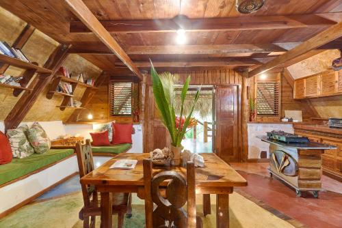 a living room with a table and a couch at CHALET TROPICAL bio-hotel in Las Galeras