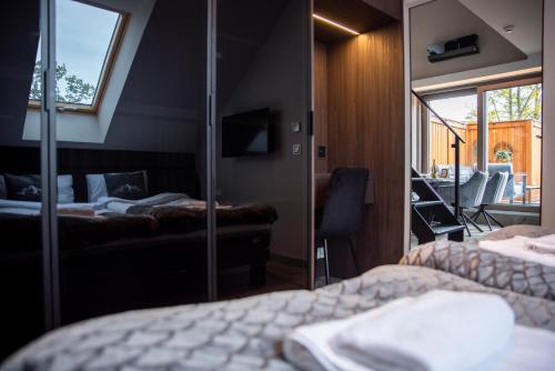a hotel room with two beds and a mirror at SZKLARSKA VIEW Luxury Apartment Jacuzzi in Szklarska Poręba