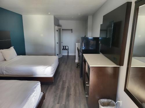 a small room with two beds and a television at Motel 6 Vallejo, CA - Napa Valley in Vallejo