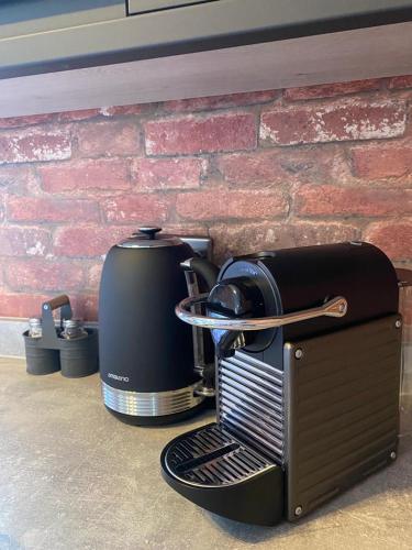 a toaster sitting on a counter next to a brick wall at 1 bed flat with parking near town centre in Emsworth
