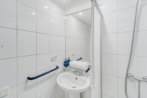 a white bathroom with a sink and a shower at Bay Dream 2B W/Wifi, Grill & View. in San Antonio