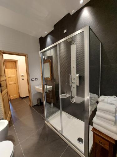 a bathroom with a glass shower and a sink at Villa Ghiron in Torriglia