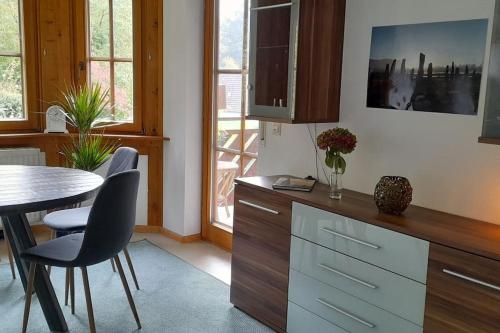 a kitchen with a table and chairs and a dining room at Gemütliche Waldrandlage in Badenweiler Sehringen Ferienwohnung in Badenweiler