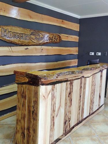 a wooden counter in a room with a wall at Morrena Lodge in Torres del Paine