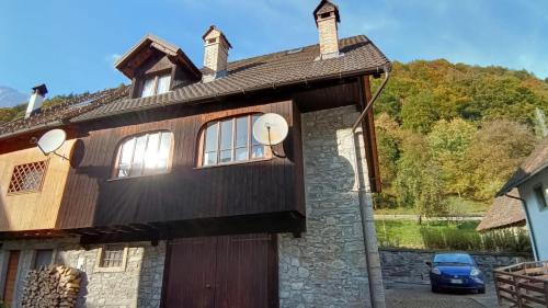 a house with a large wooden door and windows at Casa Gonano in Prato Carnico