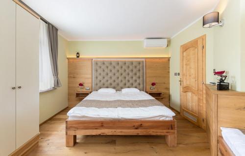 a bedroom with a large bed in a room at Apartma Rozika in Ptuj