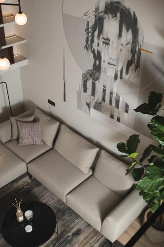 a living room with a couch and a painting on the wall at Urban Lofts in Chania Town