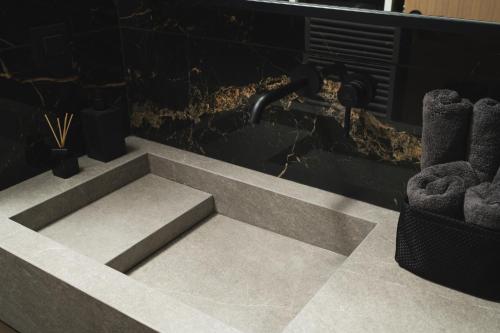 a bathroom with a concrete sink and a sink at Urban Lofts in Chania Town
