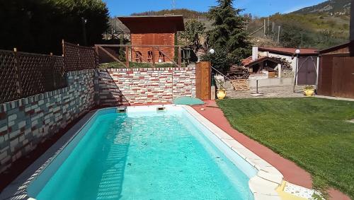 a swimming pool in the backyard of a house at casa ginefra in Tito