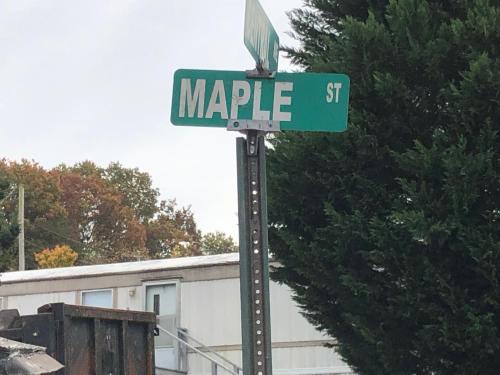 a street sign for maple street on a pole at Twin Oaks in Bryson City