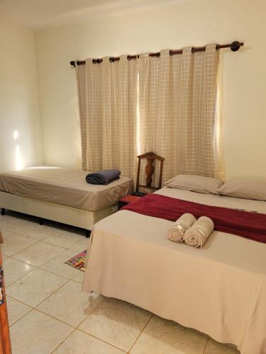 a bedroom with two beds with towels on them at Canastra Eco Hospedagem in São Roque de Minas