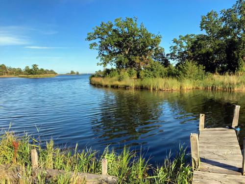 a view of a lake with a dock at Brygghuset, Solviken in Rockneby
