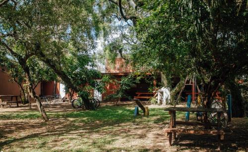 a picnic table under a tree in a park at Cabañas Los Timbó in Ituzaingó